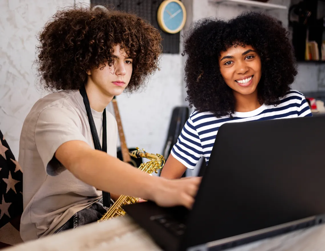 parent assisting their child in setting up for an online music lesson, showcasing the importance of parental involvement and a dedicated learning space Parental support - like establishing a practice routine and fostering open communication with the teacher - contributes to a child's musical success. Practicing Musician provides resources to help parents navigate online learning and nurture growth