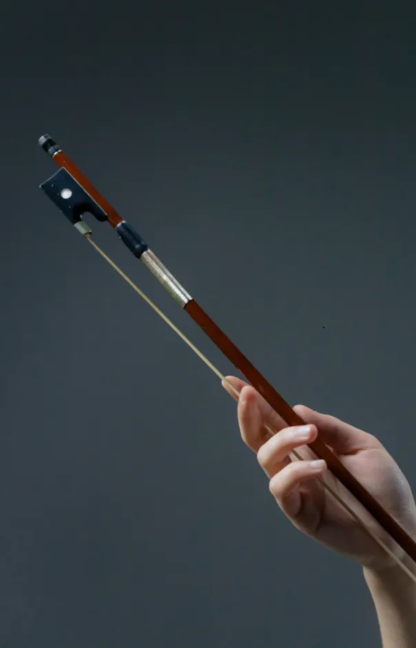 violin bow in a hand testing bow tension, Violin Bow Tension